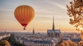 colorful hot air balloon flying over a medieval city with towers and churches at sunset - Royalty Free Stock Photo