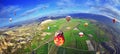 Colorful hot air balloon flying over rock landscape in blue sky