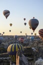 Colorful Hot air balloon flying over rocks and valley landscape at Cappadocia, Goreme Turkey Royalty Free Stock Photo