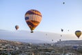 Colorful Hot air balloon flying over rocks and valley landscape at Cappadocia, Turkey Royalty Free Stock Photo