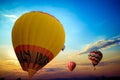 Colorful hot air balloon flying on sky at sunset. Royalty Free Stock Photo