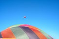 colorful hot air balloons against blue sky. Big balloon and small balloon in distance. Royalty Free Stock Photo