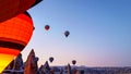 Colorful hot air balloons begining to fly at sunrise in Cappadocia Royalty Free Stock Photo