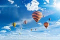 Colorful hot air balloons fly in blue sky with white clouds Royalty Free Stock Photo