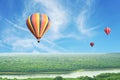 hot air balloons flying above high forest with beautiful sky background Royalty Free Stock Photo