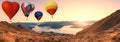 Colorful hot air balloons flying above high mountain at sunrise with beautiful sky background in roys peak track, New Zealand. Pan Royalty Free Stock Photo