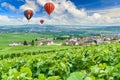 Colorful hot air balloons flying over champagne Vineyards at montagne de Reims, France