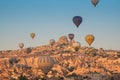 Colorful hot air balloons flying over the Goreme city in Cappadocia Royalty Free Stock Photo