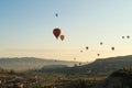 Colorful hot air balloons flying over the landscape of the Red Valley, Rose Valley, close to Goreme, Cavusin, Cappadocia, Turkey Royalty Free Stock Photo
