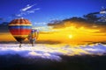 Colorful hot air balloons flying over the mountain covered by morning fog at sunrise