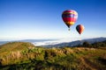 Colorful hot-air balloons flying over the mountain with sunrise and morning Thailand Royalty Free Stock Photo