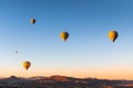 Colorful hot air balloons flying over the mountains in Cappadocia, Turkey Royalty Free Stock Photo