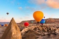 Colorful hot air balloons flying over the mountains in Cappadocia, Turkey Royalty Free Stock Photo