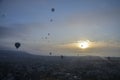 Hot air balloons flying over mountains landscape and the valley at Cappadocia in the sunrise sky at foggy morning Royalty Free Stock Photo