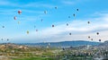 Colorful hot air balloons flying over rock landscape at Cappadocia Turkey Royalty Free Stock Photo