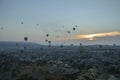 Hot air balloons flying over the valley and rock formations with fairy chimneys near Goreme, Cappadocia, Turkey Royalty Free Stock Photo