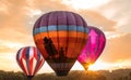 Colorful hot air balloons near horizon as the sun sets at Warren County Farmer`s Fair on 8/1/17