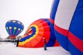 Colorful hot air balloons prepare to launch at a balloon festival