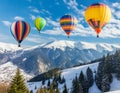 Colorful hot air balloons soaring over snowy mountain landscape