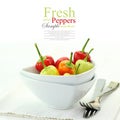 Colorful hot mini chili peppers in white bowl