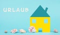 Colorful house on a blue colored background with sea shells, booking an appartment, hotel or lounge for vacation, holidays