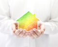 Colorful house in hands. Energy saving concept. Royalty Free Stock Photo