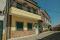 Colorful house with large balcony on deserted alley