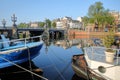 Colorful houseboats, overlooking Amstel river, with Blauwbrug bridge in the background