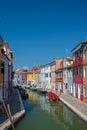 Colorful houses along a canal on Burano island Italy