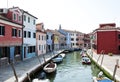 Colorful houses along a canal in Burano, Venice, Italy. Burano is an island in Venetian Lagoon known for its colored homes. Royalty Free Stock Photo