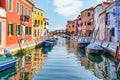 Colorful houses along the water canal in the island of Burano, Venice Royalty Free Stock Photo