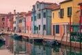 Colorful houses along water channel in Burano island in Italy