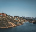 Colorful houses dot the hillsides of the fishing town of Kangaamiut, West Greenland. Icebergs from Kangia glacier in Royalty Free Stock Photo