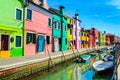 Colorful houses near canal on Burano island, Venice, Italy Royalty Free Stock Photo