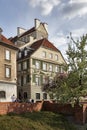 Colorful houses near the fortress wall in the old town in Warsaw. Cherry blooms Royalty Free Stock Photo