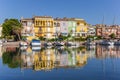 Colorful houses with reflection in the water of Port Saplaya in