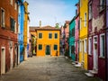 Colorful houses on a small traditional square at Burano island, Venice