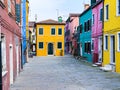 Colorful houses on a small traditional square at Burano island, Venice