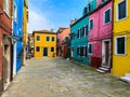 Colorful houses on a small traditional square at Burano island, Venice