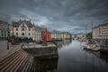 Colorful houses and waterway with boats in the city Alesund in Norway