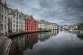 Colorful houses and waterway with boats in the city Alesund in Norway