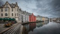 Colorful houses and waterway with boats in the city Alesund in Norway