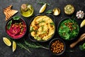 Colorful hummus bowls. Flat-lay of various vegetarian dips hummus.