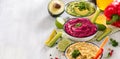 Colorful hummus, vegan snack, beetroot and avocado hummus, vegetarian eating, copy space background