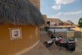 Colorful huts in Rajsathani village, Jaisalmer, India. Blue sky and white clouds background