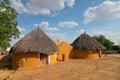 Colorful huts in Rajsathani village, Jaisalmer, India. Blue sky and white clouds background