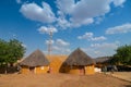 Colorful huts in Rajsathani village, Jaisalmer, India. Blue sky and white clouds background