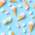 Colorful ice cream cones with marshmallows create a delightful summer pattern on a bright blue background Royalty Free Stock Photo