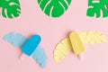 Colorful ice cream and monstera tropical leaves isolated on pastel pink background abstract Royalty Free Stock Photo