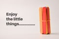 Colorful ice cream sticks with text ENJOY THE LITTLE THINGS Royalty Free Stock Photo